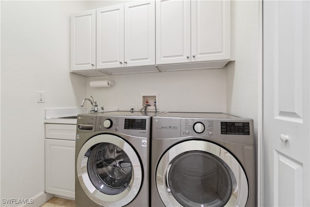 laundry area with cabinets, sink, and separate washer and dryer