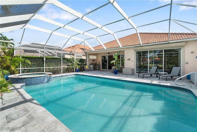 view of swimming pool featuring glass enclosure, a patio, and an in ground hot tub