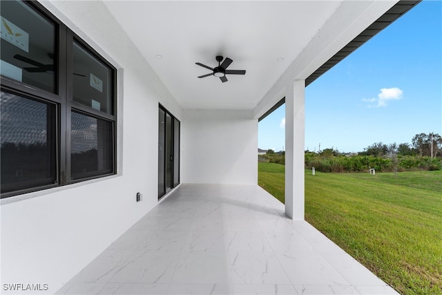 view of patio featuring ceiling fan