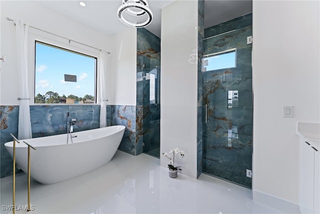 bathroom featuring tile walls, vanity, and plus walk in shower