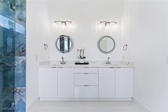 bathroom featuring vanity, a shower with shower door, and tile patterned flooring