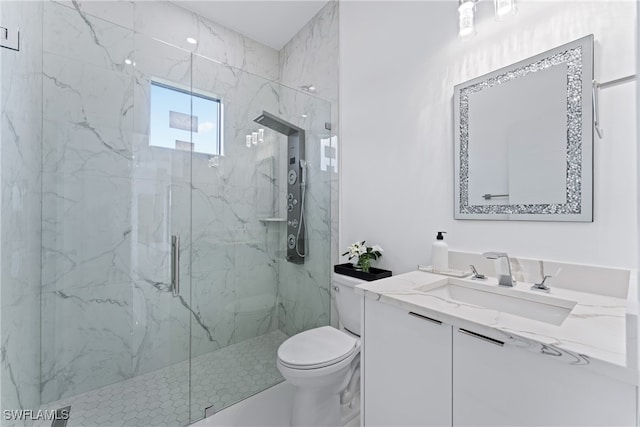 bathroom with vanity, toilet, and a shower with shower door