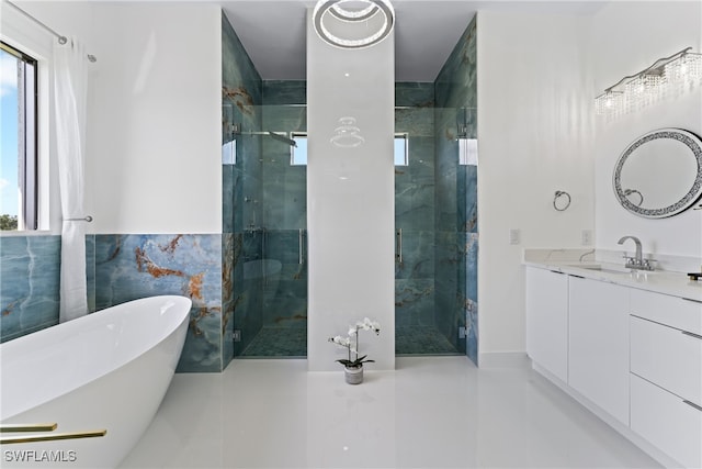 bathroom featuring vanity and shower with separate bathtub