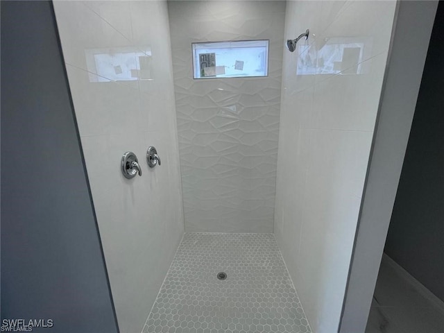 bathroom with a tile shower