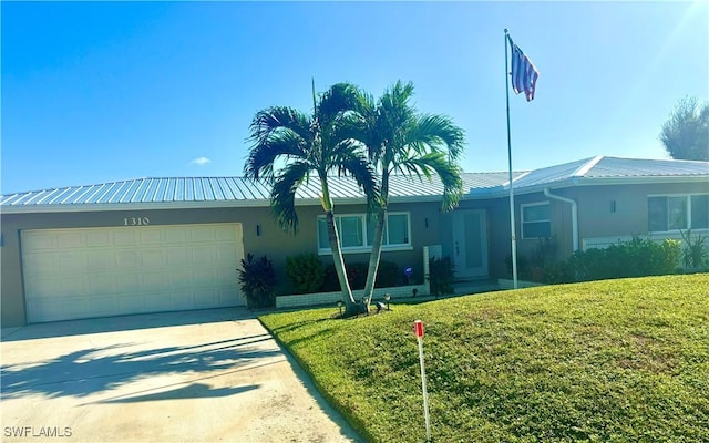 1310 Thompson St, North Fort Myers, FL 33903 - single story home with metal roof, driveway, an attached garage, and a front lawn