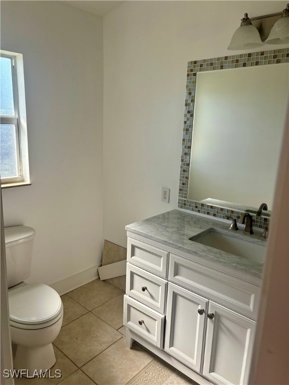 bathroom featuring toilet, vanity, and tile patterned floors