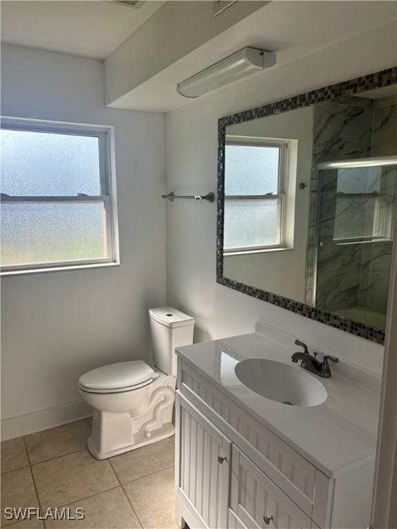 1310 Thompson St, North Fort Myers, FL 33903 - bathroom featuring vanity, toilet, a shower stall, tile patterned flooring, and baseboards