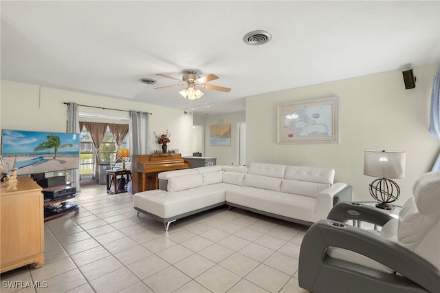 tiled living room with ceiling fan