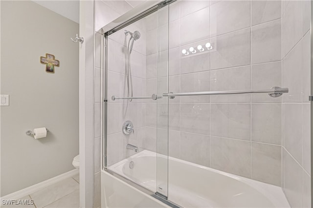 bathroom featuring tile patterned floors, toilet, and combined bath / shower with glass door