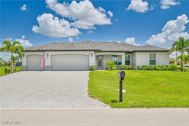 view of front of property featuring a garage and a front yard