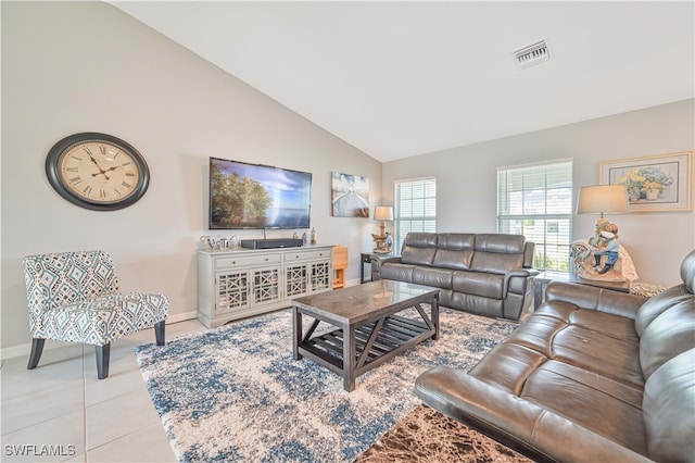 living room featuring light tile patterned floors and high vaulted ceiling