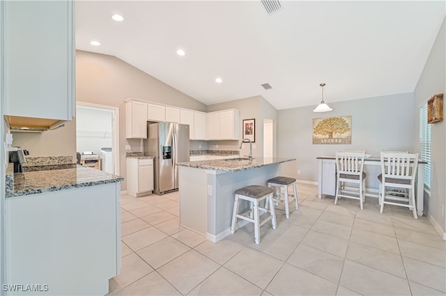 kitchen featuring stone countertops, sink, white cabinets, independent washer and dryer, and stainless steel appliances