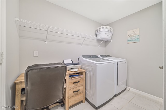 washroom with light tile patterned floors and washer and clothes dryer