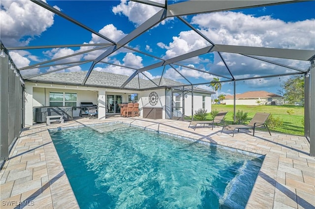 view of swimming pool with glass enclosure, a patio, and grilling area