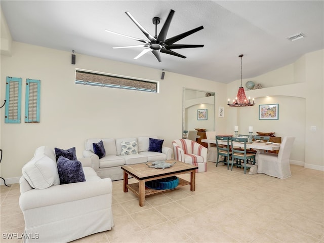 living room with ceiling fan with notable chandelier and lofted ceiling