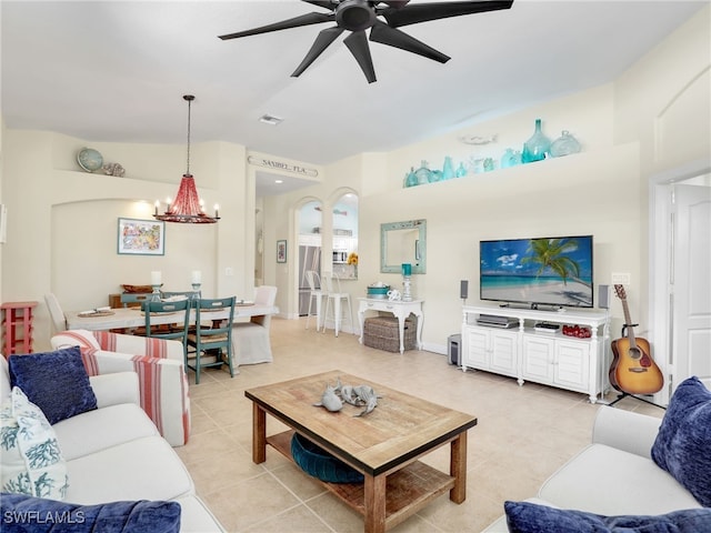 living room with ceiling fan with notable chandelier and light tile patterned flooring