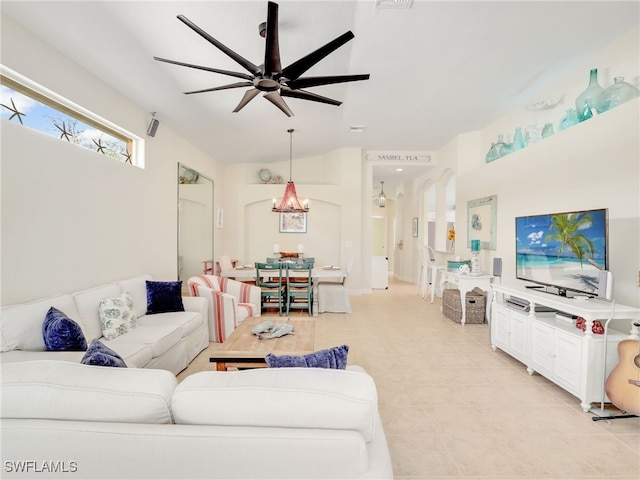 living room featuring light tile patterned floors and ceiling fan