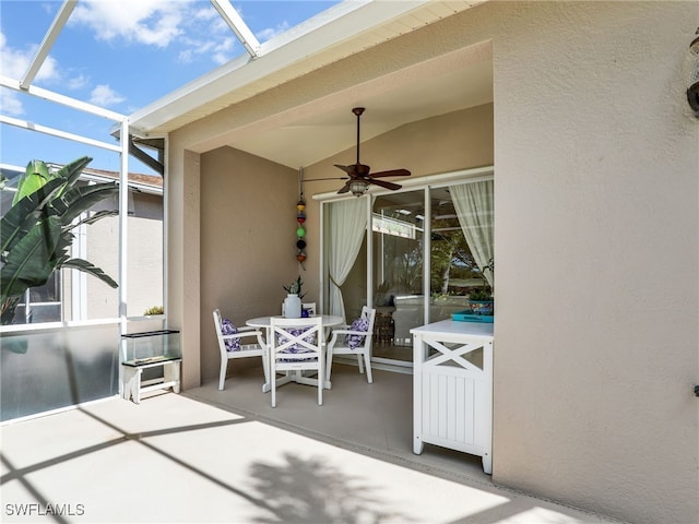 view of patio / terrace featuring ceiling fan and a lanai