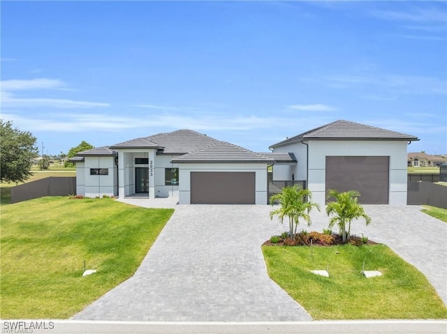 prairie-style home with a garage and a front yard