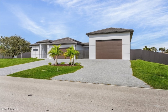 view of front of property featuring a garage and a front yard