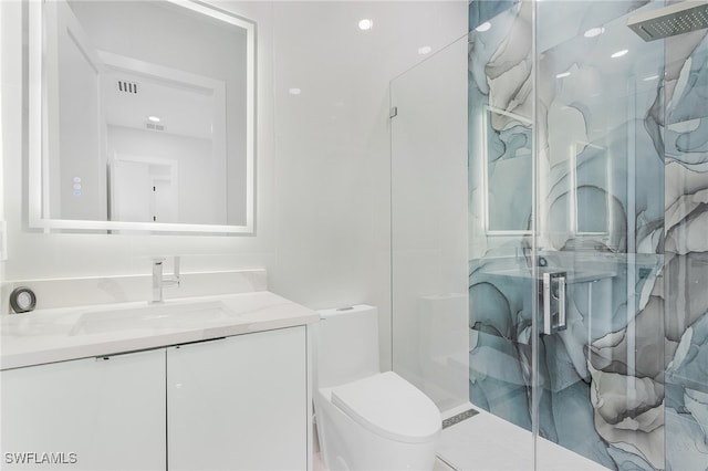 bathroom featuring vanity, toilet, and a shower with door