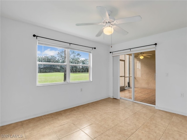 unfurnished bedroom with ceiling fan, light tile patterned floors, and a closet