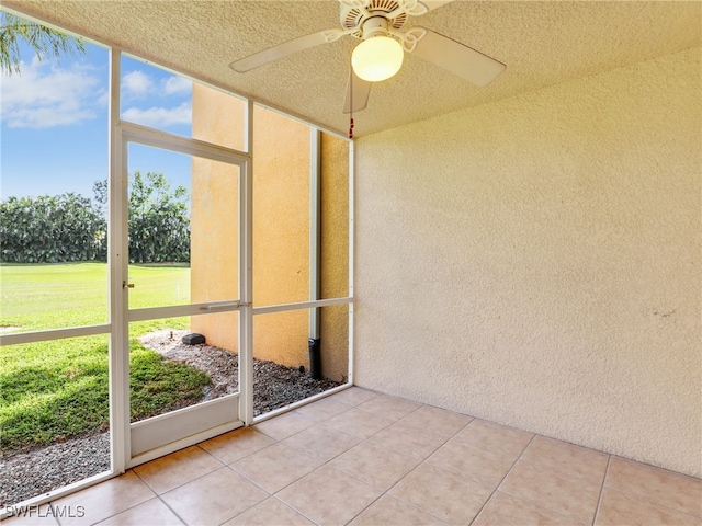 unfurnished sunroom with ceiling fan