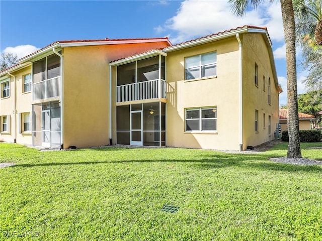 rear view of property with a yard