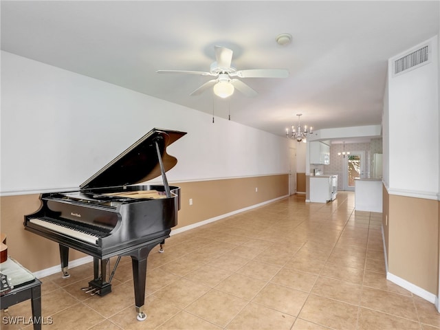 miscellaneous room featuring light tile patterned floors and ceiling fan with notable chandelier