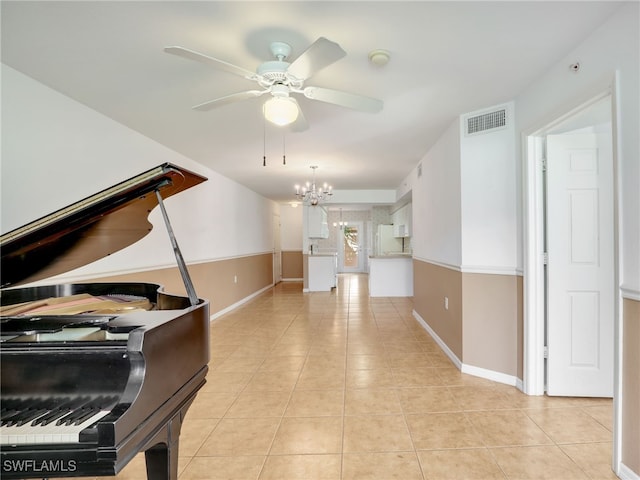 interior space featuring ceiling fan with notable chandelier