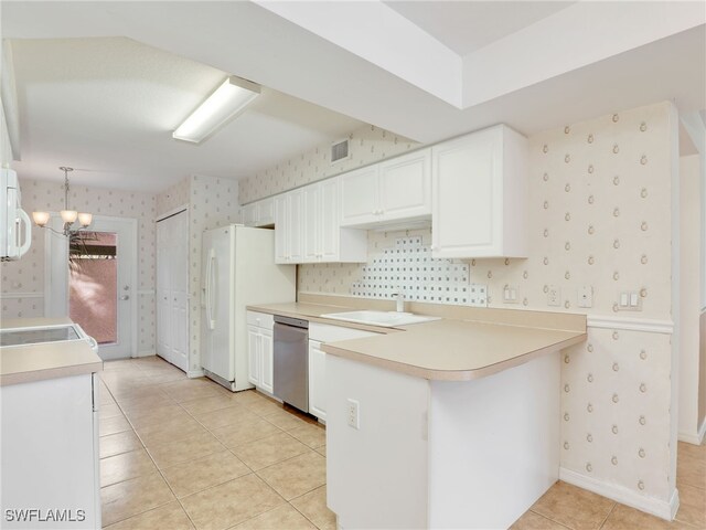 kitchen with white cabinetry, kitchen peninsula, decorative light fixtures, white appliances, and light tile patterned flooring