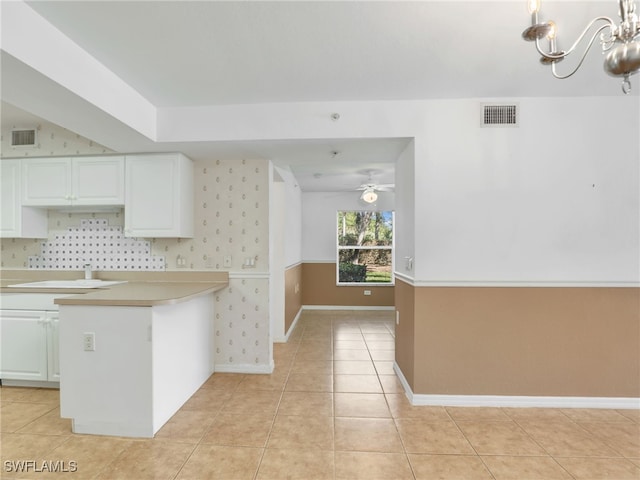 kitchen featuring white cabinets, ceiling fan, light tile patterned floors, and sink