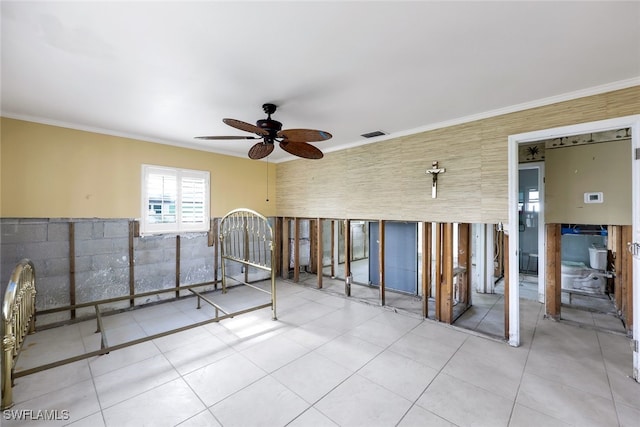 interior space with ceiling fan, tile walls, and ornamental molding