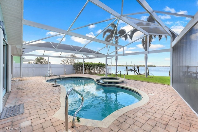 view of swimming pool featuring glass enclosure, a water view, a patio, and an in ground hot tub