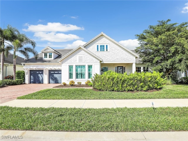 view of front of home featuring a garage and a front yard