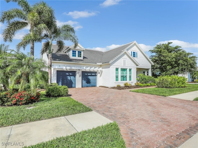 view of front of house with a garage and a front lawn