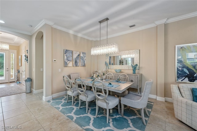 dining space with light tile patterned floors and ornamental molding