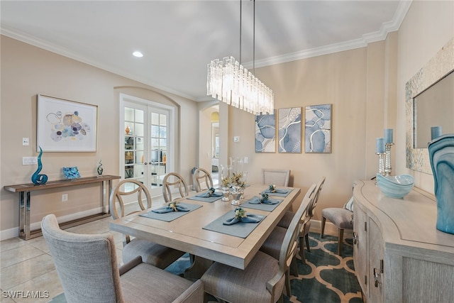 tiled dining area with french doors, a notable chandelier, and crown molding