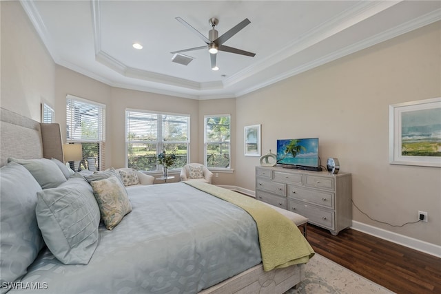 bedroom featuring ceiling fan, a tray ceiling, dark hardwood / wood-style floors, and crown molding