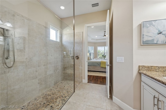 bathroom featuring ornamental molding, vanity, tile patterned flooring, and a healthy amount of sunlight