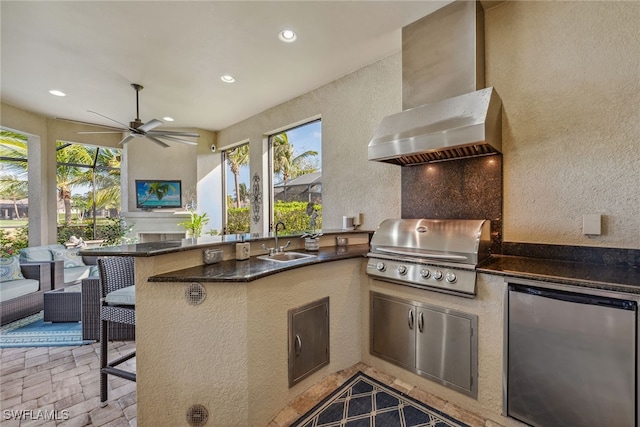 view of patio with ceiling fan, area for grilling, and sink