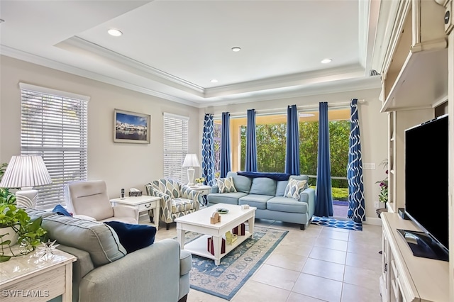 tiled living room featuring ornamental molding, a tray ceiling, and a healthy amount of sunlight