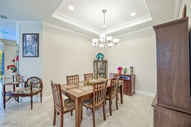 dining room with ornamental molding, a chandelier, and a raised ceiling