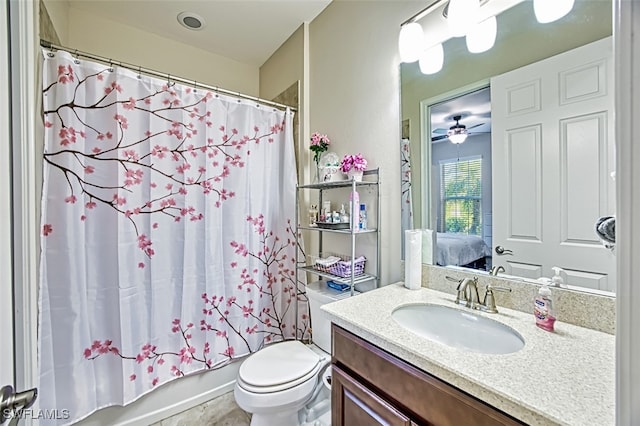 full bathroom with vanity, shower / bath combination with curtain, toilet, and ceiling fan