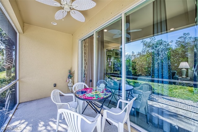 sunroom featuring ceiling fan