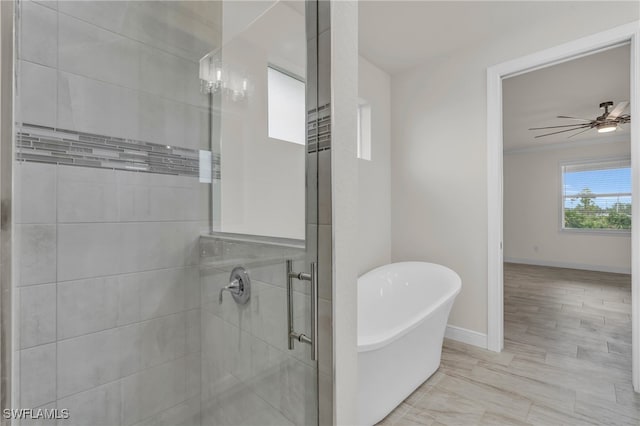 bathroom featuring shower with separate bathtub, hardwood / wood-style flooring, and ceiling fan