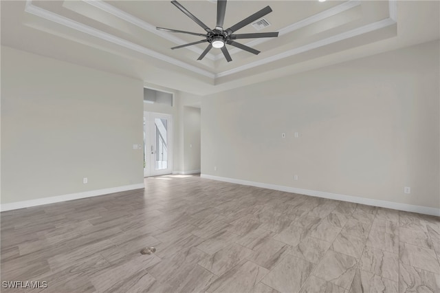 unfurnished room with crown molding, a tray ceiling, and ceiling fan