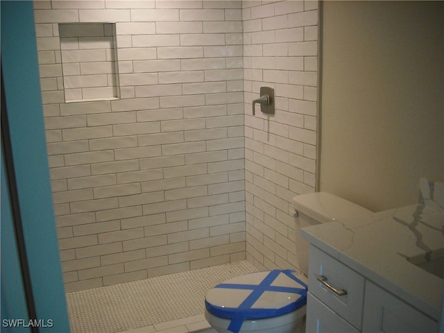 bathroom featuring toilet and a tile shower