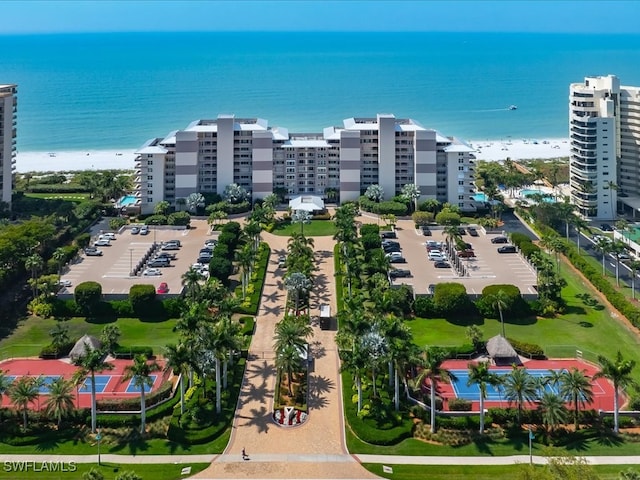 aerial view with a water view and a beach view