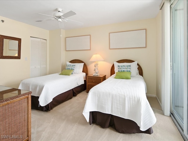 bedroom featuring light carpet, ceiling fan, and a closet